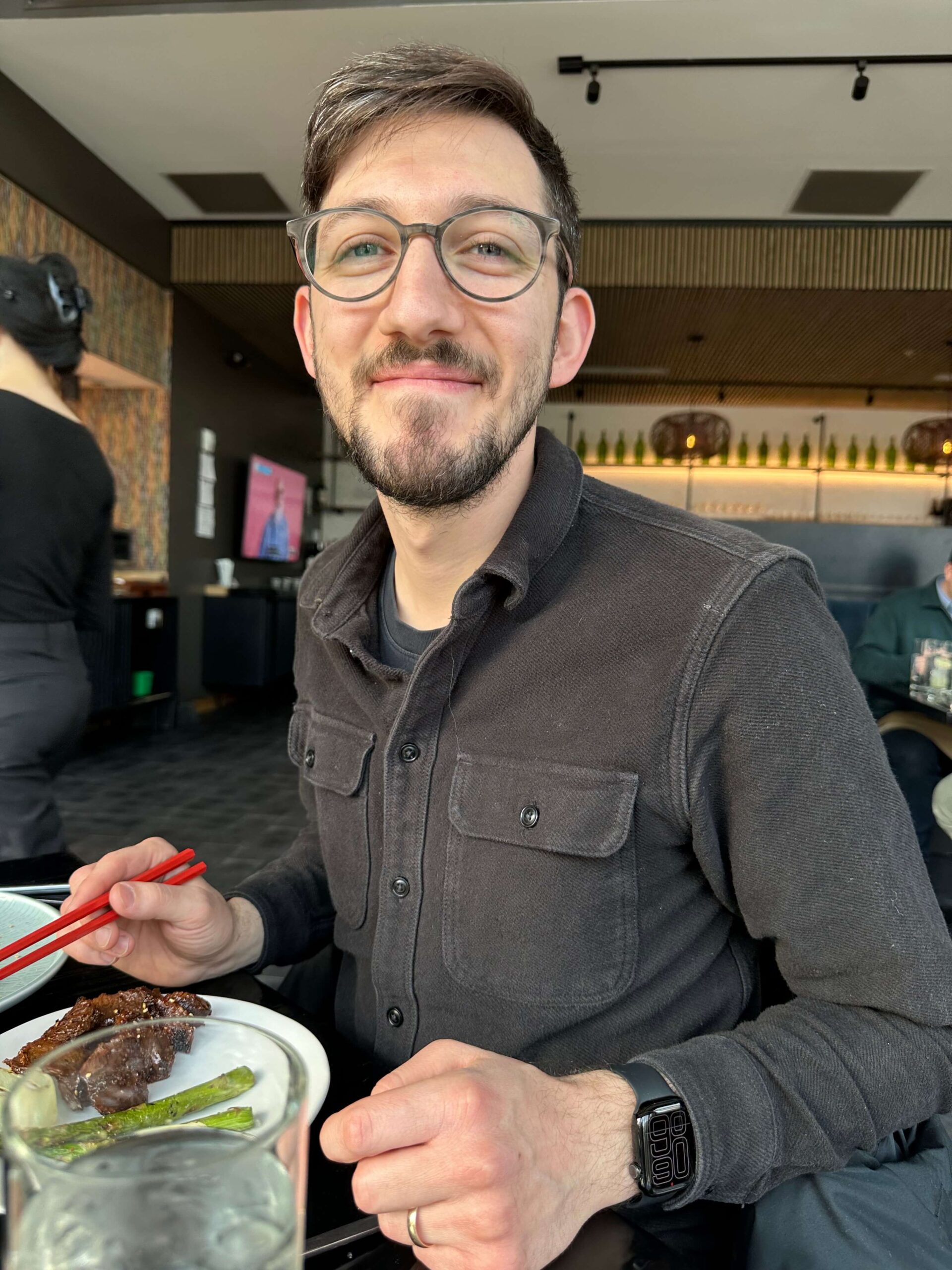 me, sitting at a restaurant eating Korean Barbecue