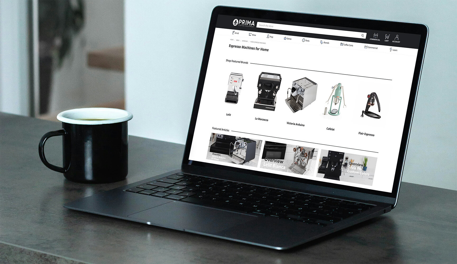 prima coffee category page on a MacBook Air beside a cup of coffee
